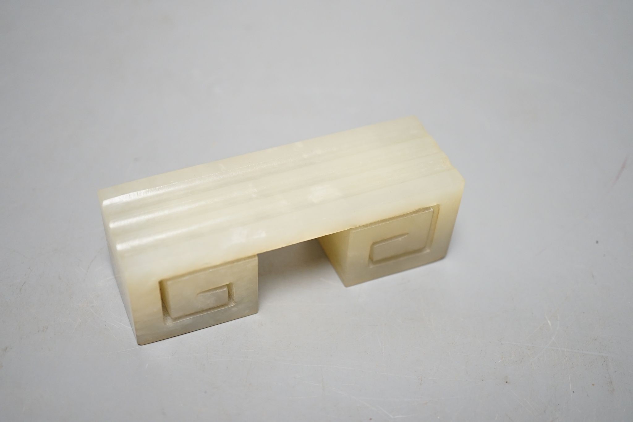 A Chinese pale celadon jade brush rest, 9.5 cms high.